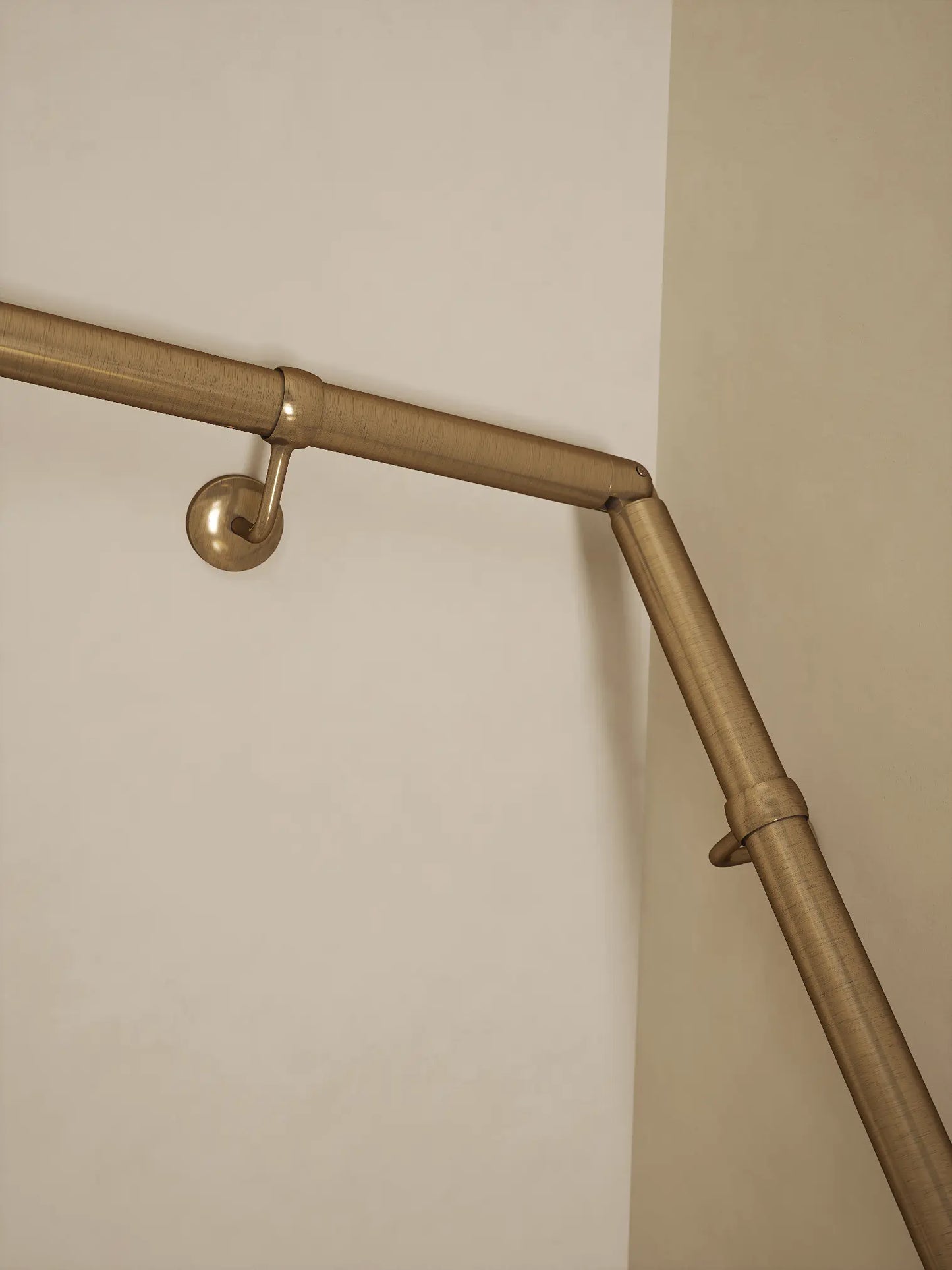Antique brass 40mm double winder handrail, close-up view of angled joint