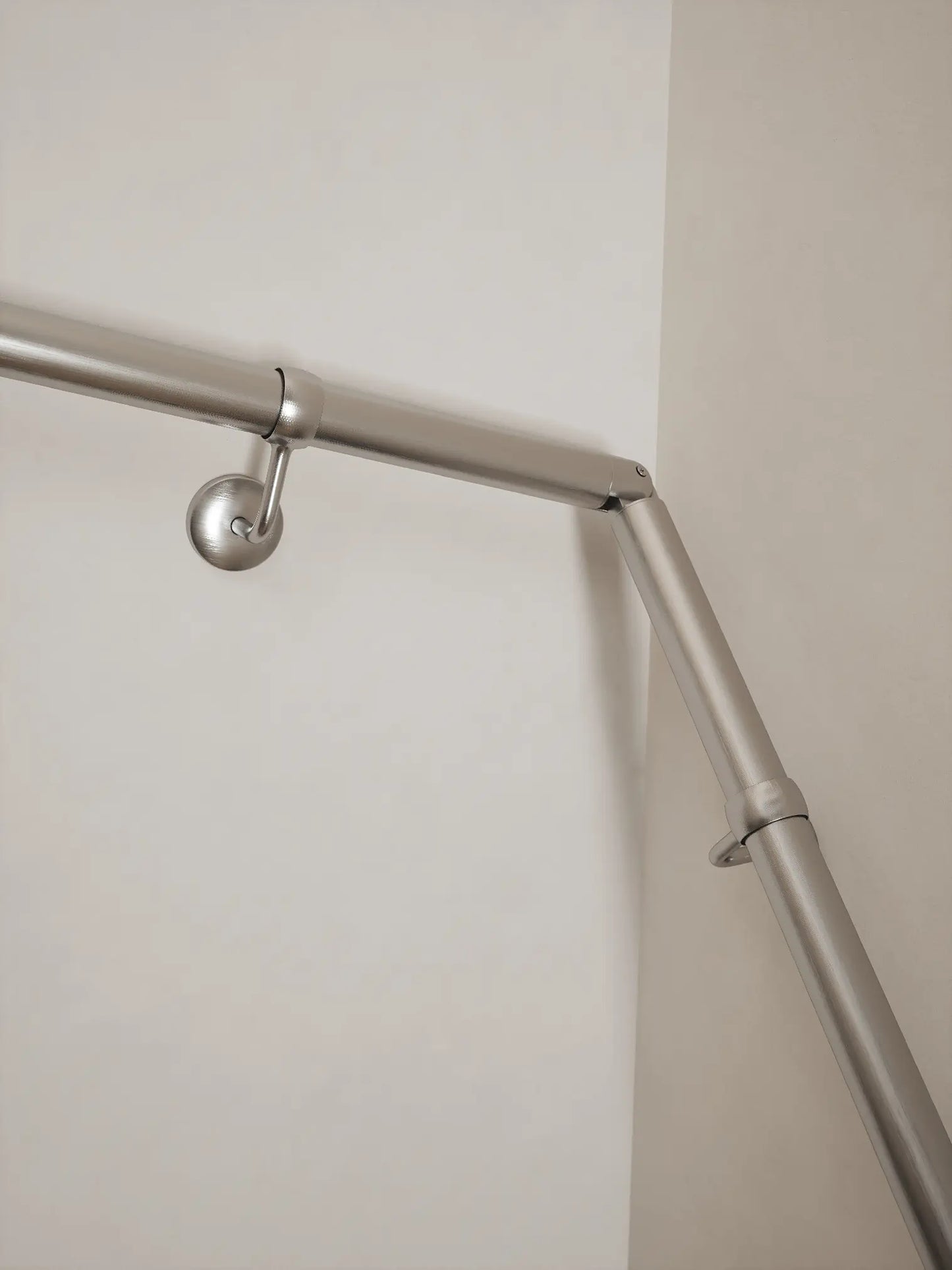 Brushed silver 40mm double winder handrail, close-up view of angled joint