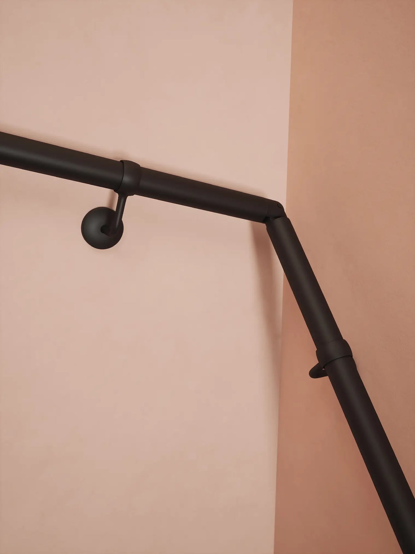 Matt black 40mm double winder handrail, close-up view of angled joint