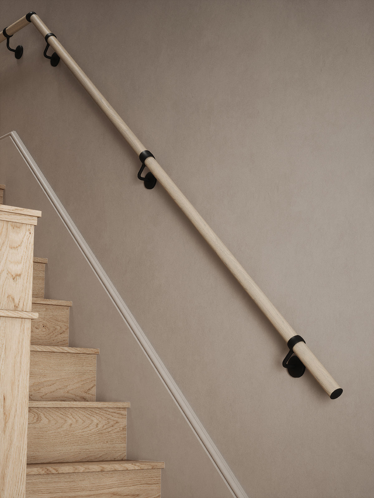Ryton Teak Quarter Landing Handrail with Kineton Matt Black brackets along a flight of stairs 