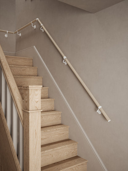 Ryton Teak Quarter Landing Handrail with Edstone Matt White brackets fitted beside wooden stairs