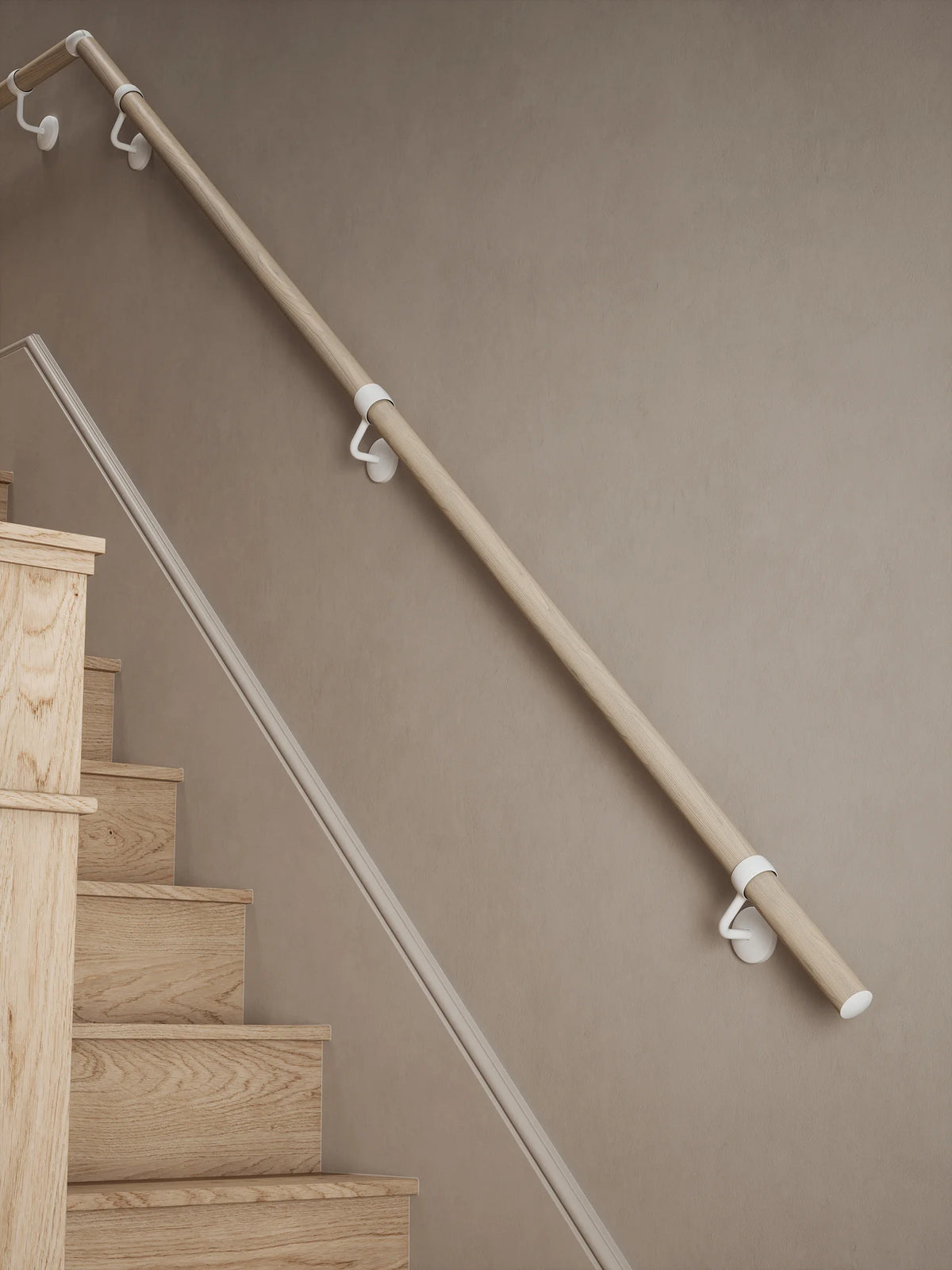 Ryton Teak Quarter Landing Handrail with Edstone Matt White brackets along a flight of wooden stairs