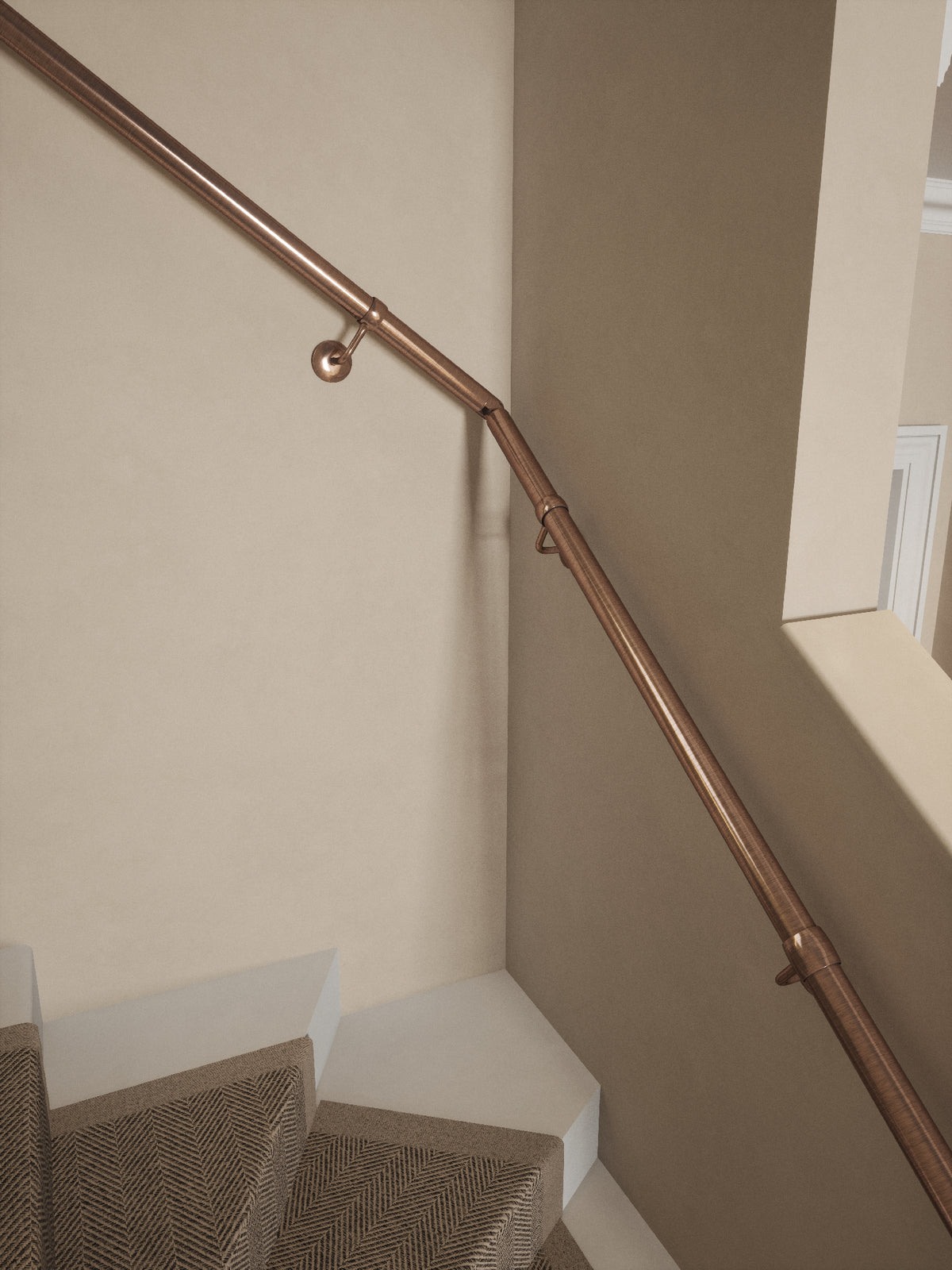 Close-up of the Sambourne Antique Copper single winder handrail turning at the winder step
