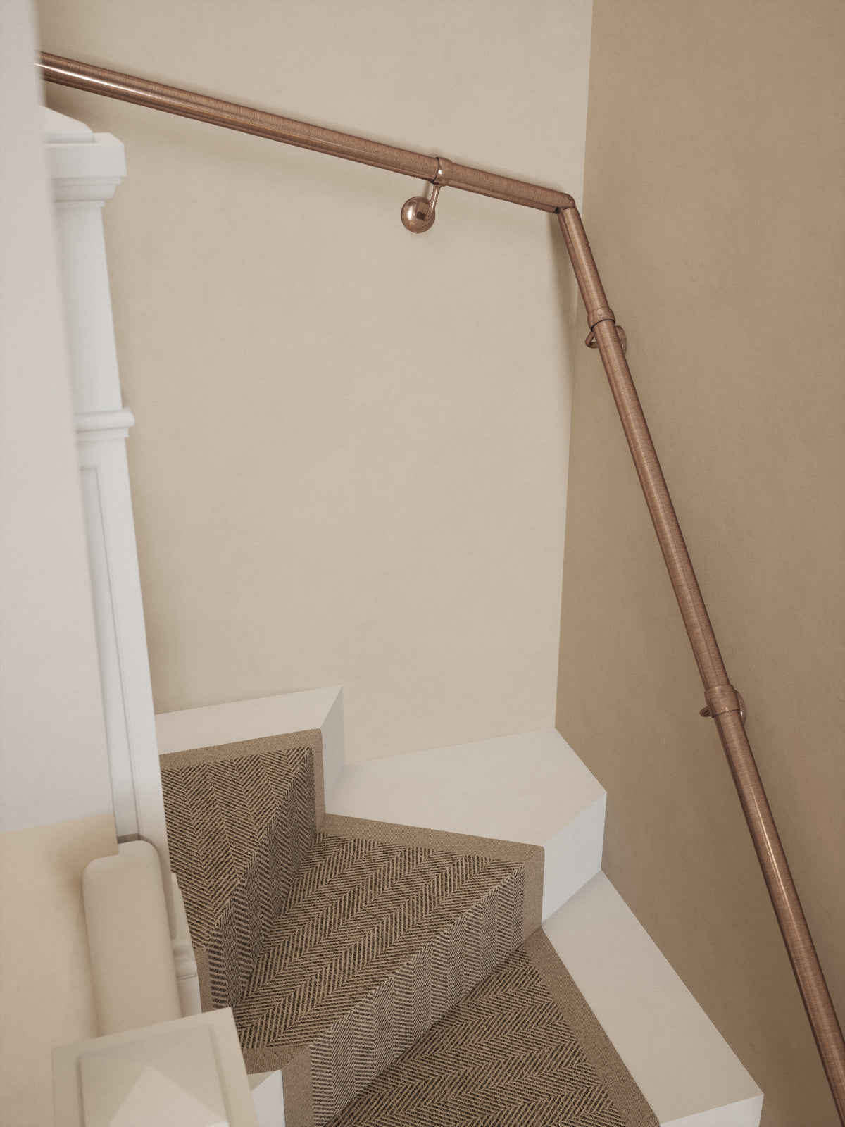 Top-down view of the Sambourne Antique Copper single winder handrail following the winder turn