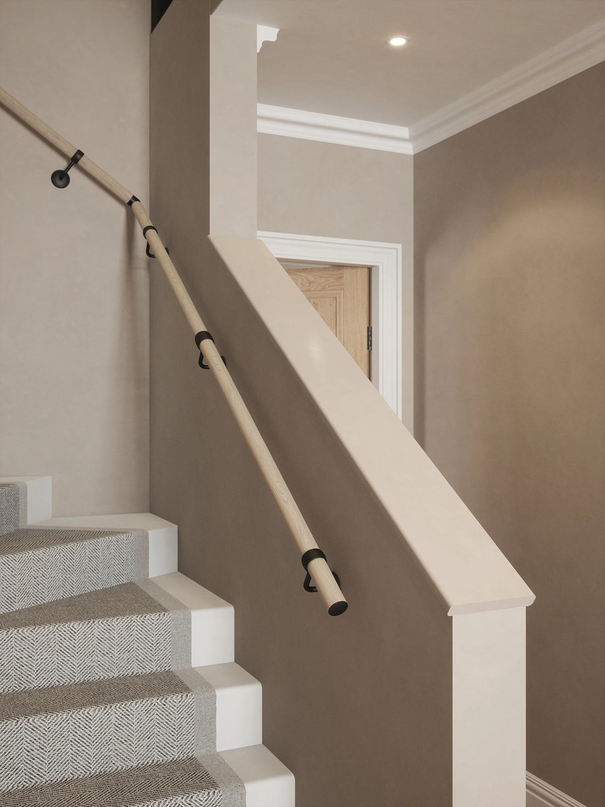 Ryton Teak Single Winder Handrail with Kineton Matt Black brackets and end caps, fitted alongside a staircase with a grey patterned runner.