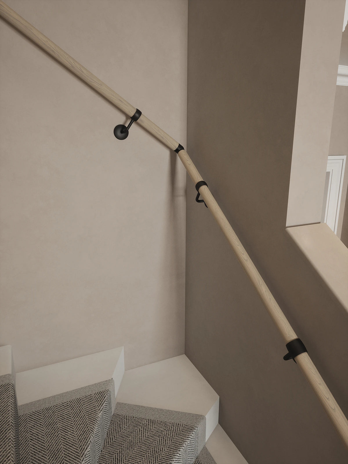 Ryton Teak Single Winder Handrail with Kineton Matt Black brackets and an adjustable elbow following the staircase turn.