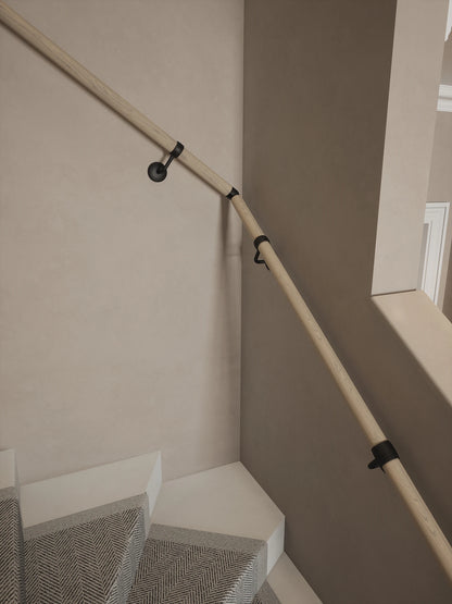 Ryton Teak Single Winder Handrail with Kineton Matt Black brackets and an adjustable elbow following the staircase turn.