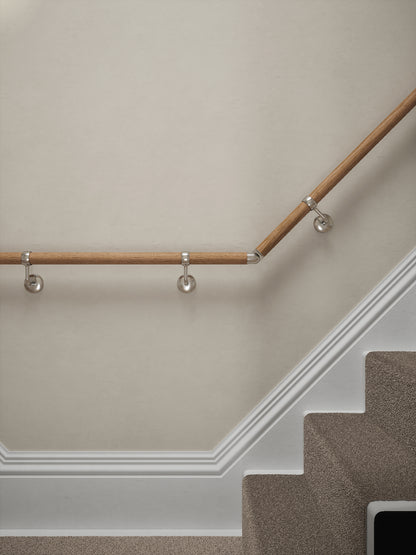 Stoneleigh Red Oak T-shape handrail with silver wall brackets at the turn