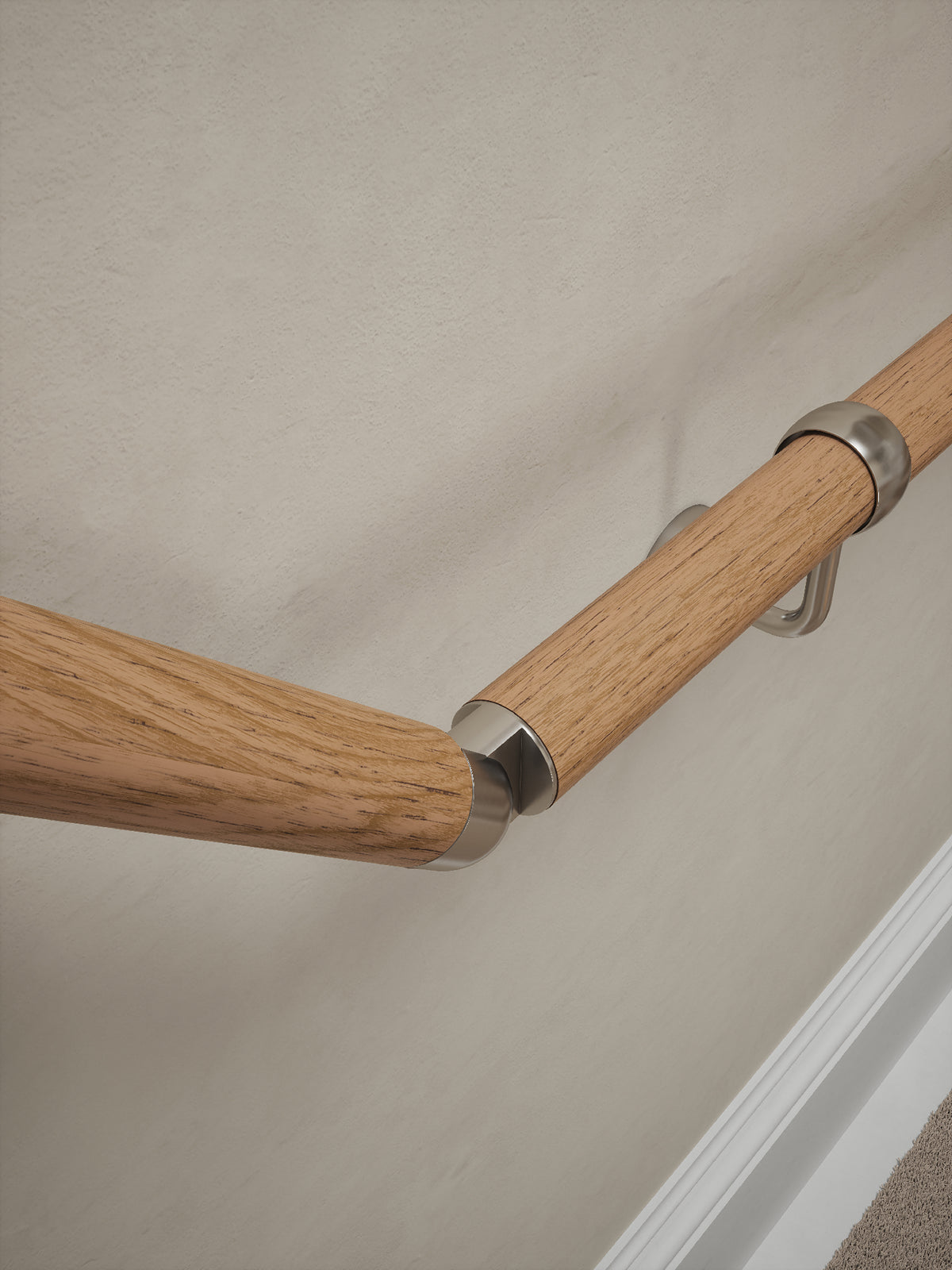 Close-up of the Stoneleigh Red Oak handrail with silver elbow and bracket