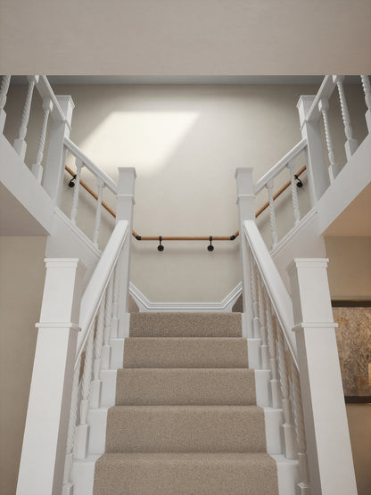 Stoneleigh Red Oak T-shape handrail with matt black fittings on a split staircase leading to the landing
