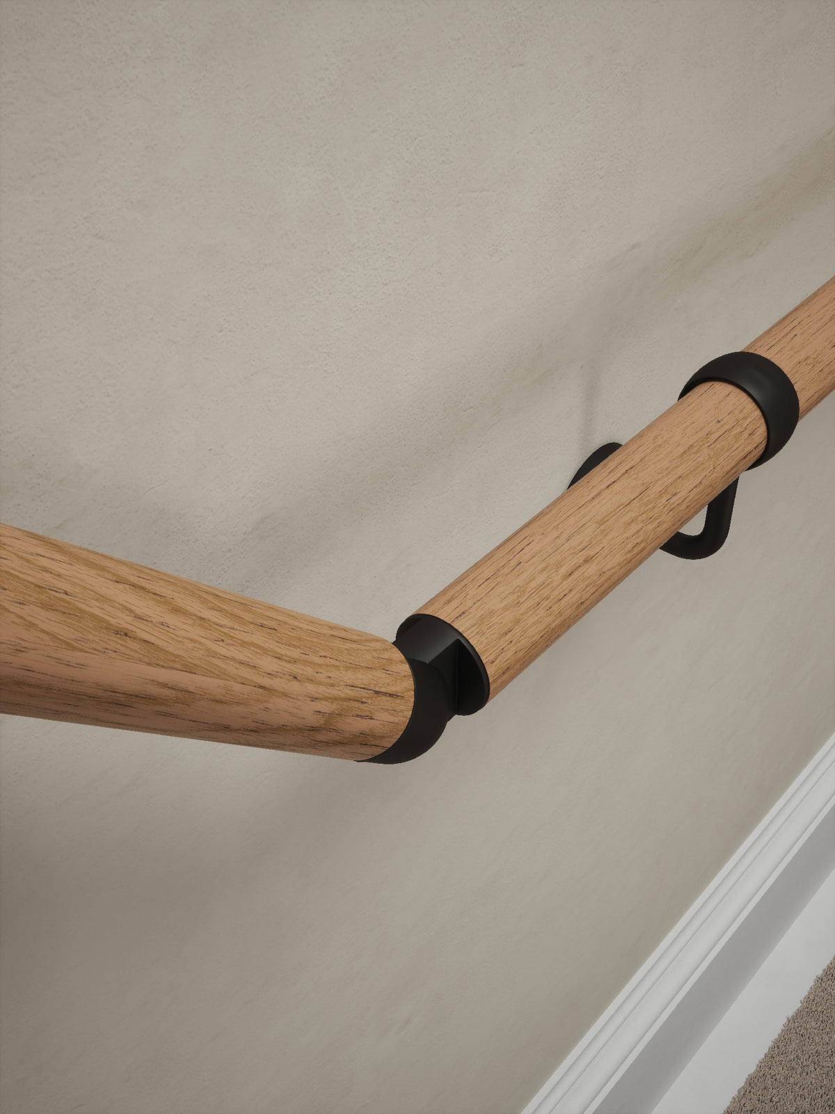 Close-up of the Stoneleigh Red Oak handrail with matt black elbow and bracket