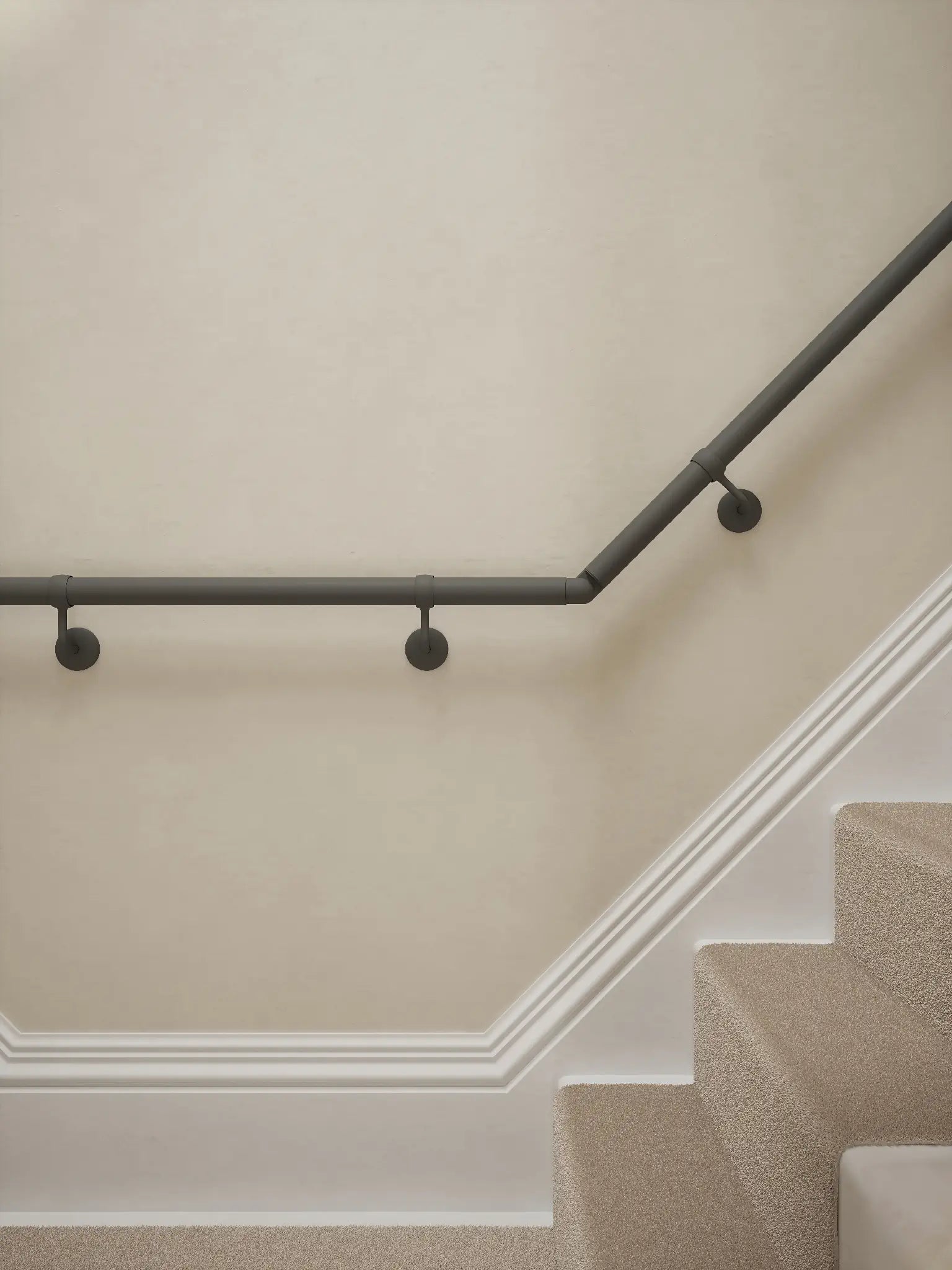 Luddington textured grey t shape handrail showing brackets and elbows with a rise.