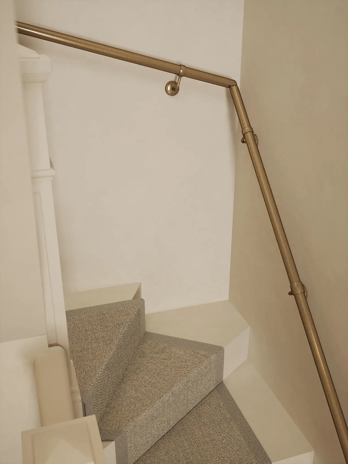 Antique brass 40mm double winder handrail following staircase turn, angled view