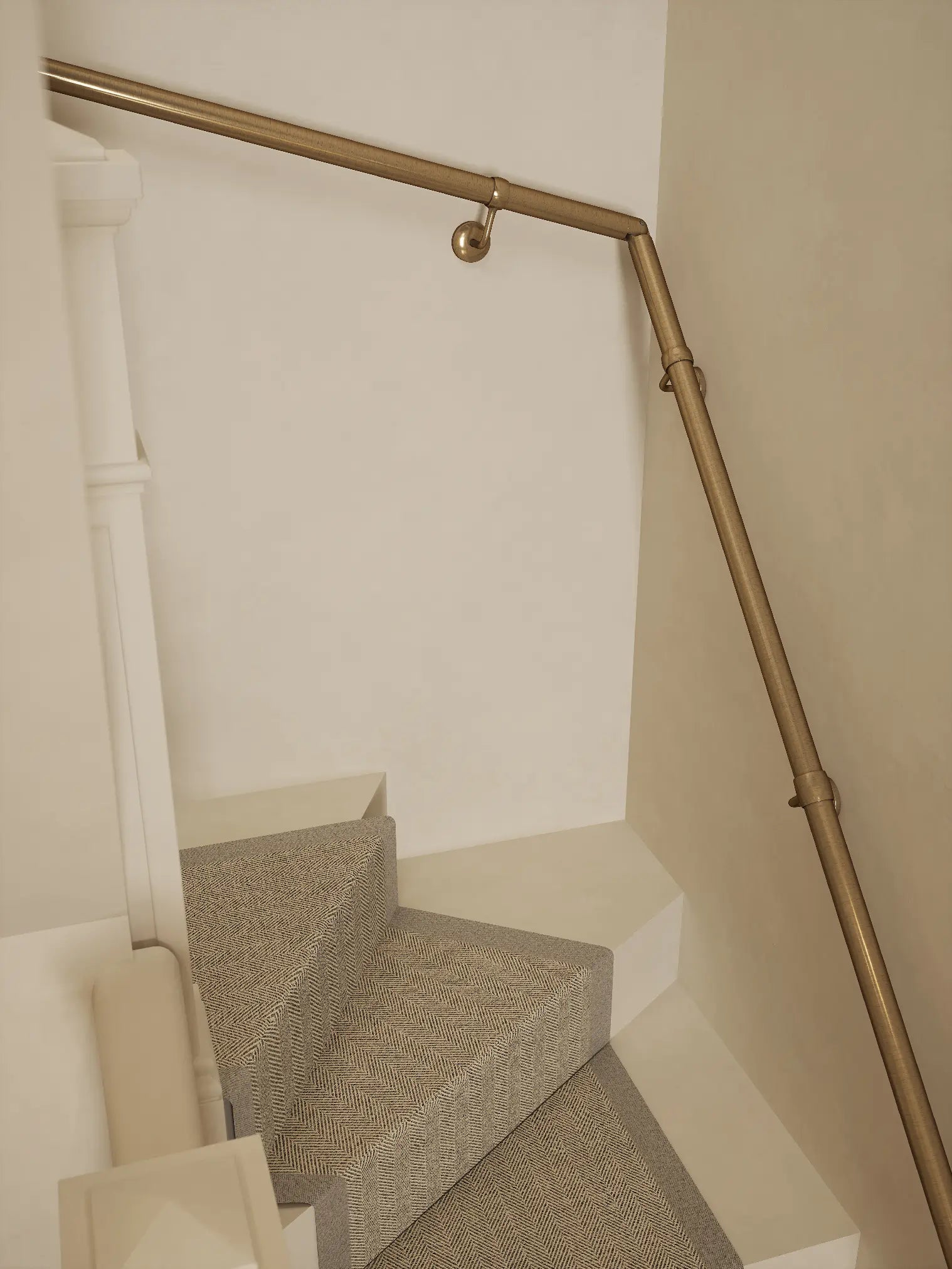 Antique brass 40mm double winder handrail following staircase turn, angled view
