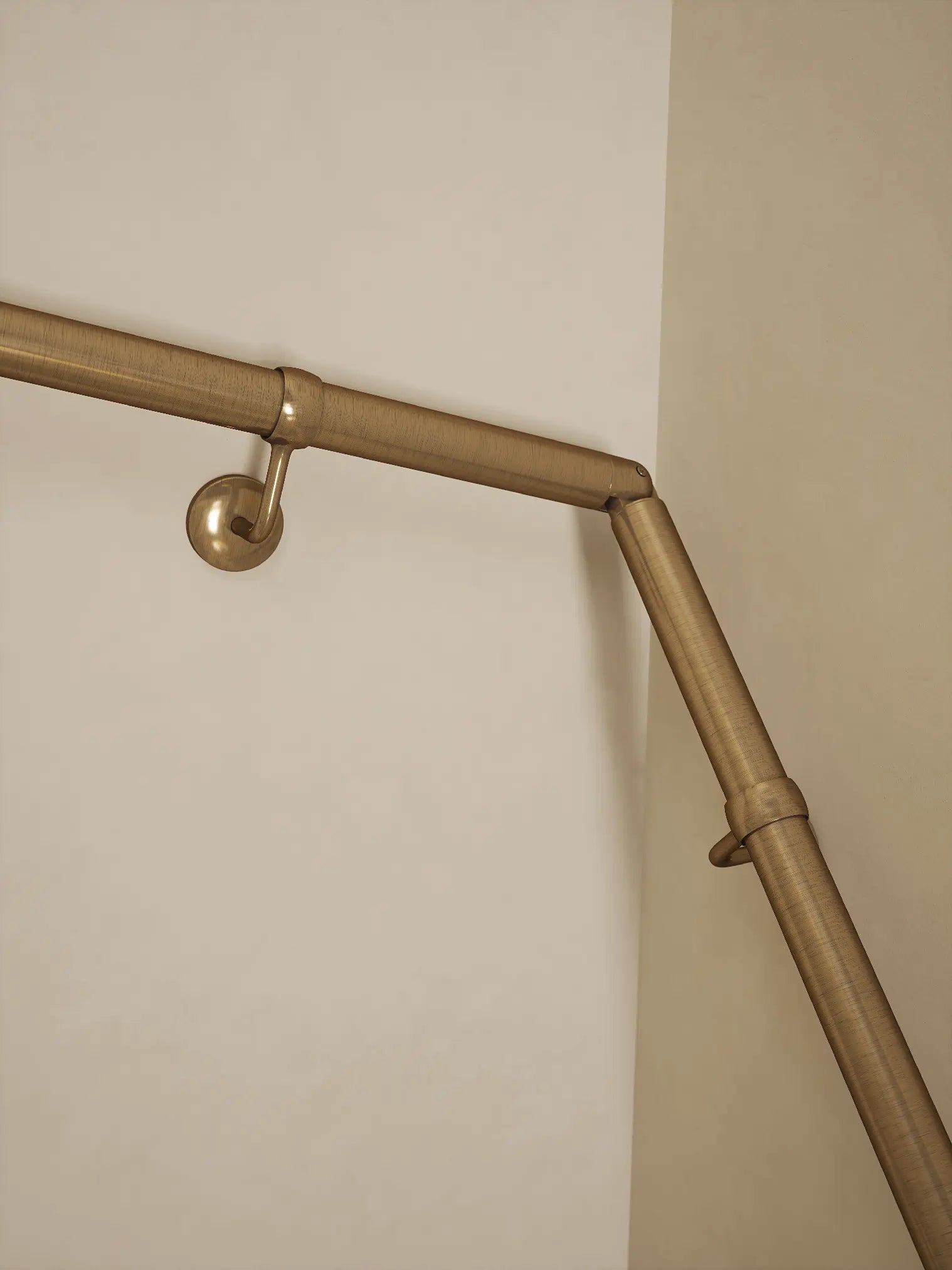 Antique brass 40mm double winder handrail, close-up view of angled joint