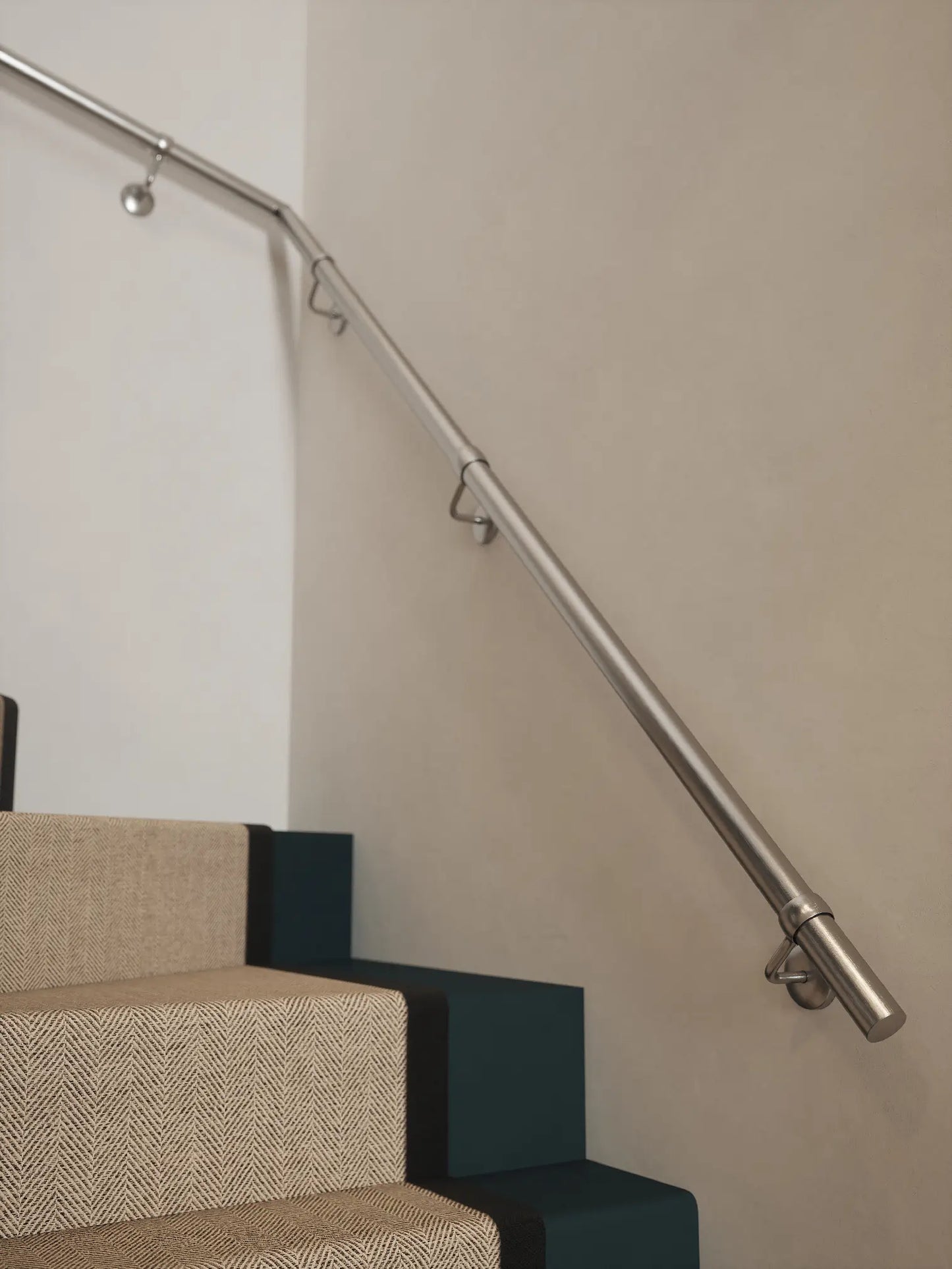 Brushed silver 40mm double winder handrail mounted on staircase wall, side view