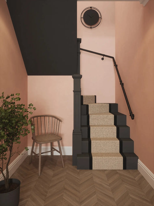 Matt black 40mm double winder handrail installed on staircase wall, front view