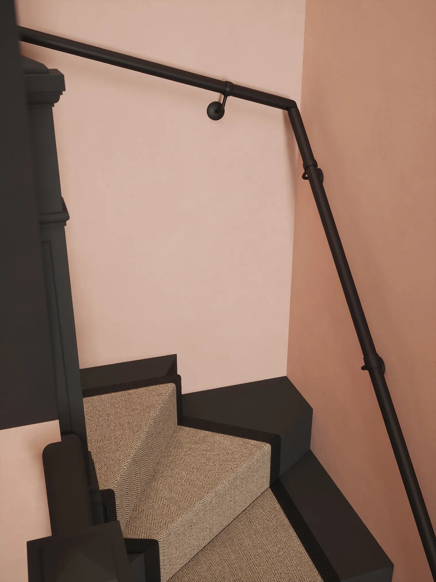 Matt black 40mm double winder handrail mounted on staircase wall, side view