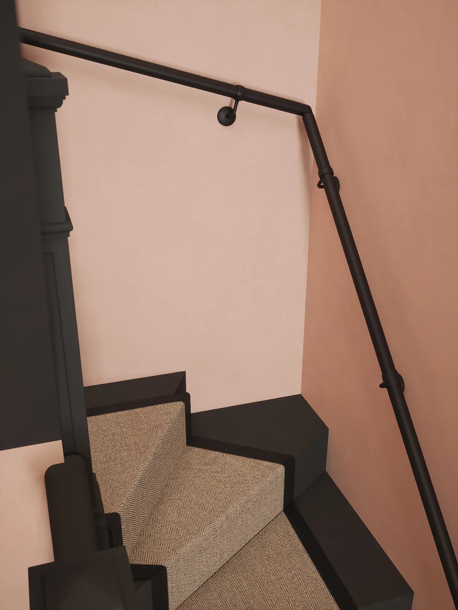 Matt black 40mm double winder handrail mounted on staircase wall, side view