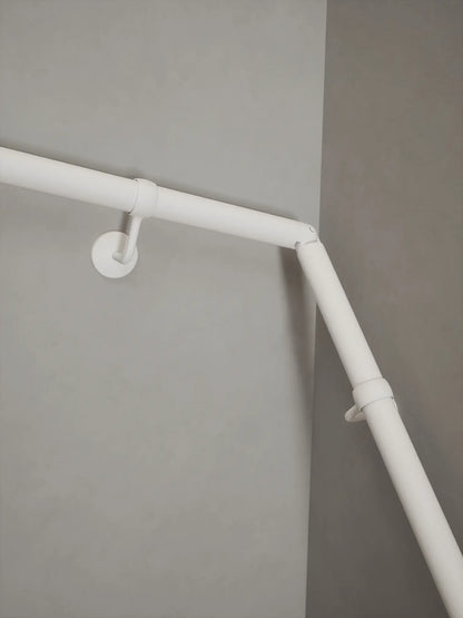Matt white 40mm double winder handrail, close-up view of angled joint