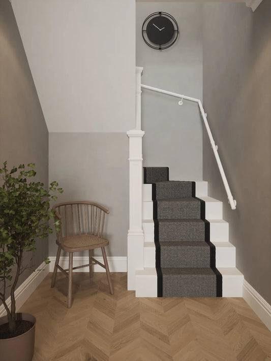 Matt white 40mm double winder handrail installed on staircase wall, front view