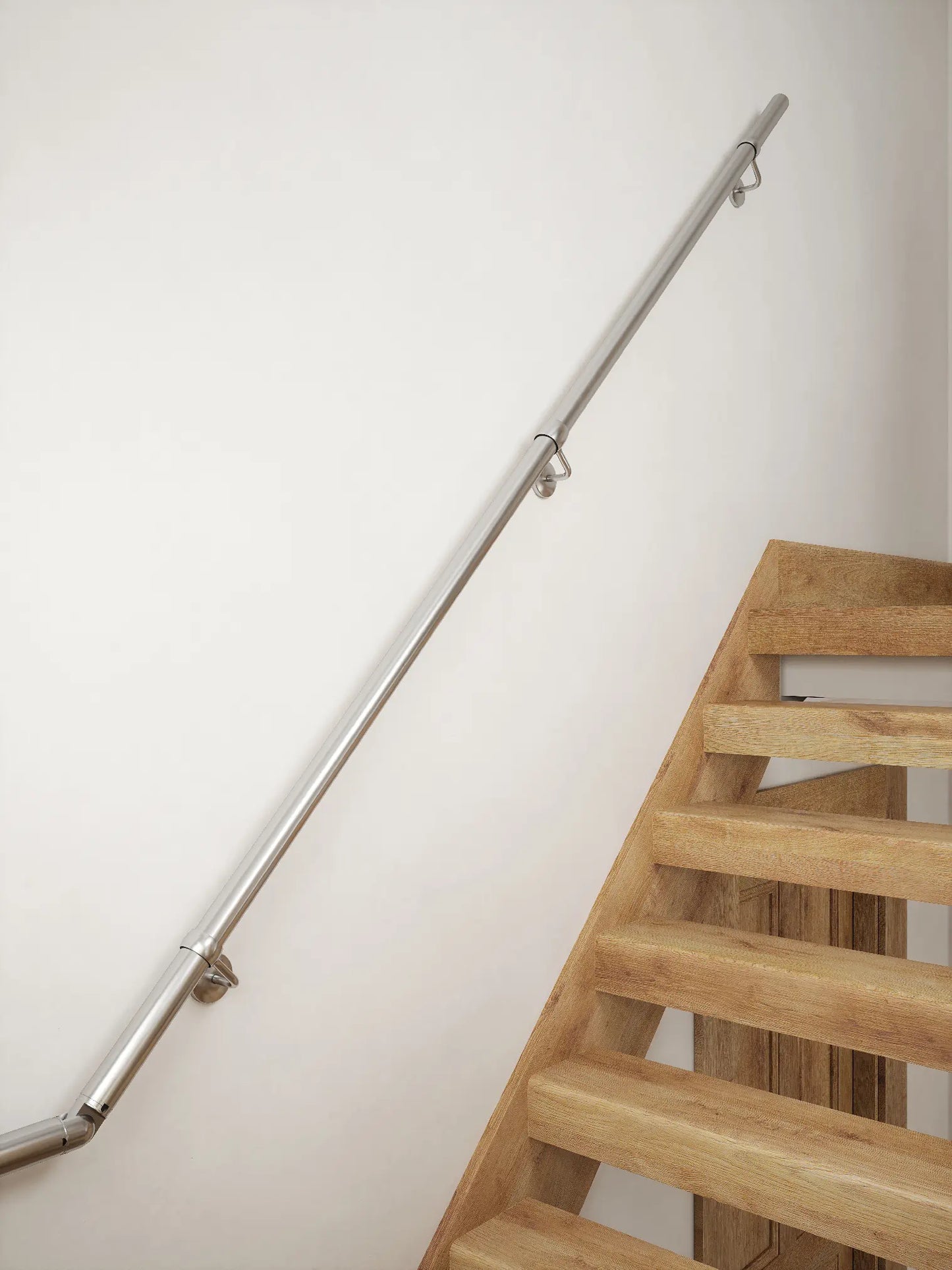 Brushed silver 40mm half turn handrail mounted on staircase wall, side view