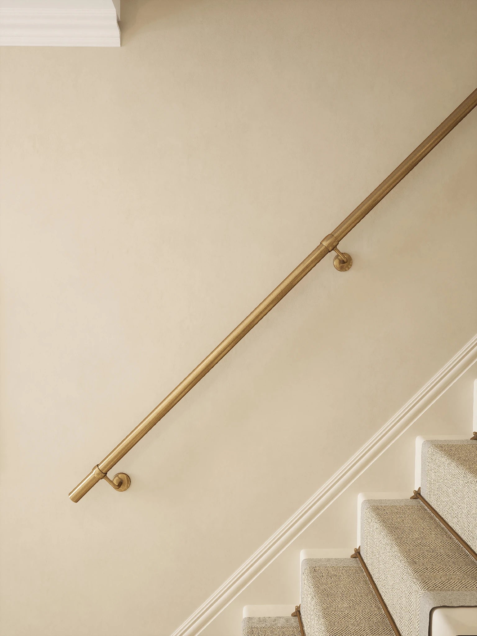 Antique brass 3.6m straight run handrail mounted on staircase wall, side view