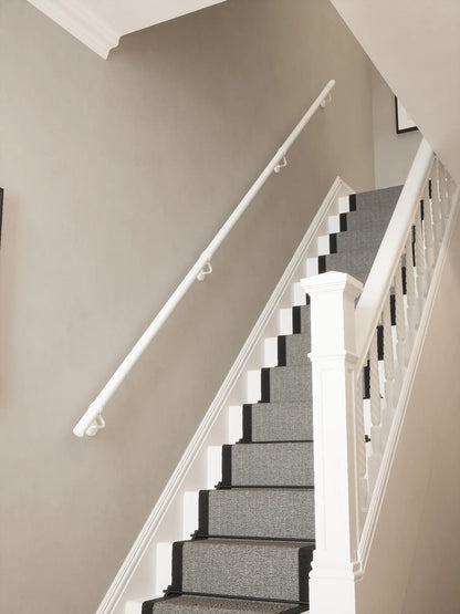 Matt white 40mm straight run handrail installed on staircase wall