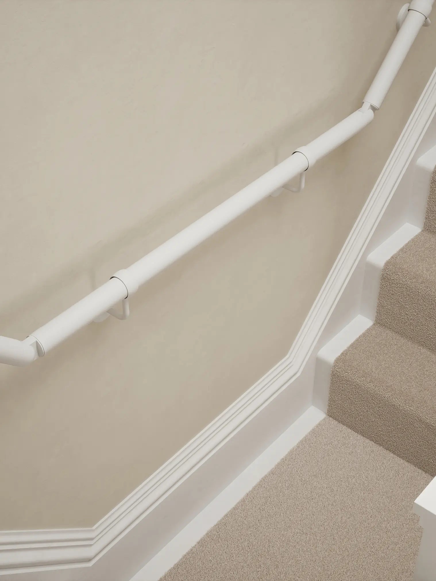 Edstone Matt White wall-mounted handrail installed on a T-shape staircase, alternate front view – Handrails Direct UK supplier of modular indoor handrails and fittings