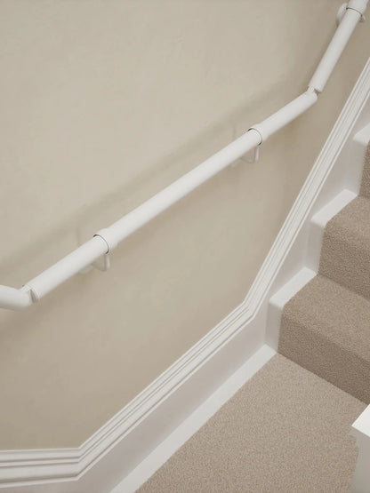 Edstone Matt White wall-mounted handrail installed on a T-shape staircase, alternate front view – Handrails Direct UK supplier of modular indoor handrails and fittings