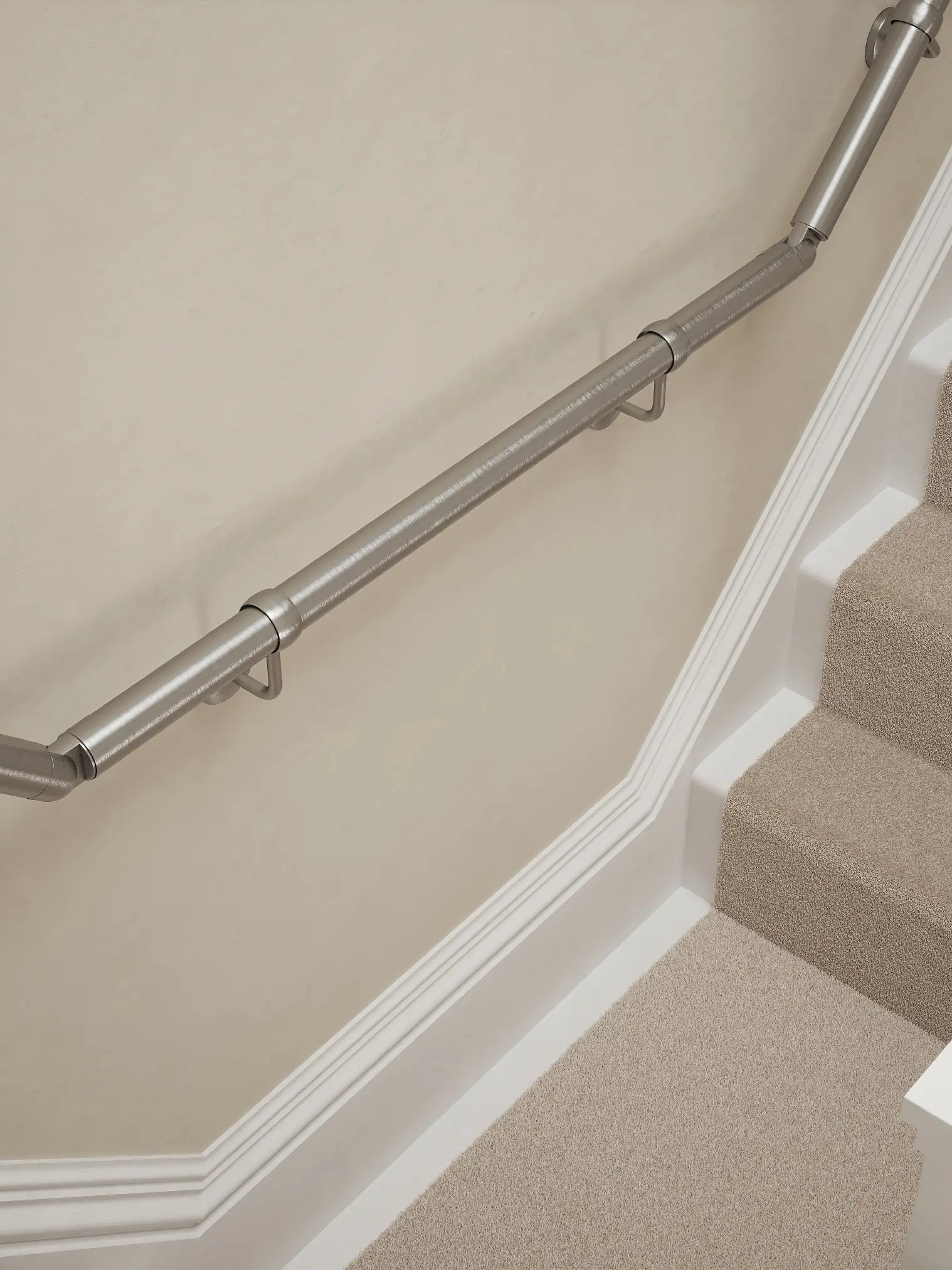 Harbury Brushed Silver wall-mounted handrail installed on a T-shape staircase, alternate front view – Handrails Direct UK supplier of modular indoor handrails and fittings