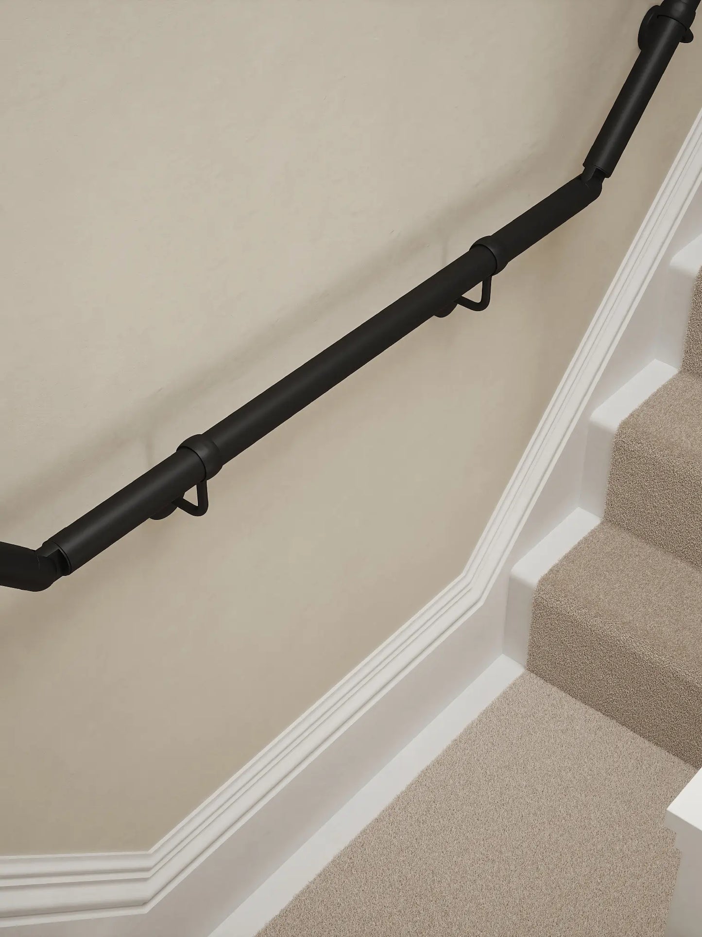 Matt Black wall-mounted handrail installed on a T-shape staircase, alternate front view – Handrails Direct UK supplier of modular indoor handrails and fittings