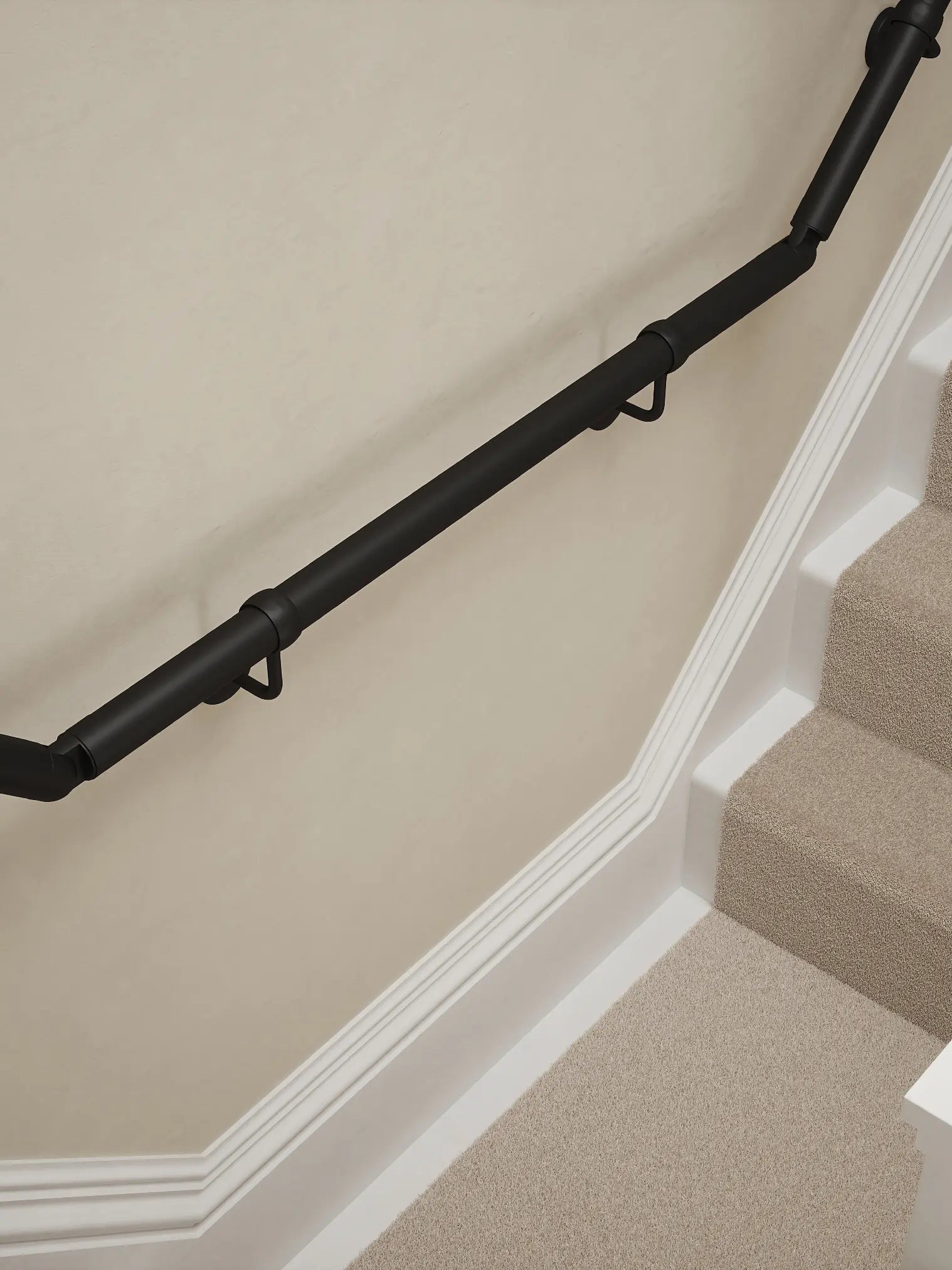 Matt Black wall-mounted handrail installed on a T-shape staircase, alternate front view – Handrails Direct UK supplier of modular indoor handrails and fittings