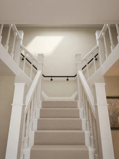 Kineton Matt Black wall-mounted handrail fitted on a T-shape staircase, front view – Handrails Direct UK supplier of modular indoor handrails and fittings