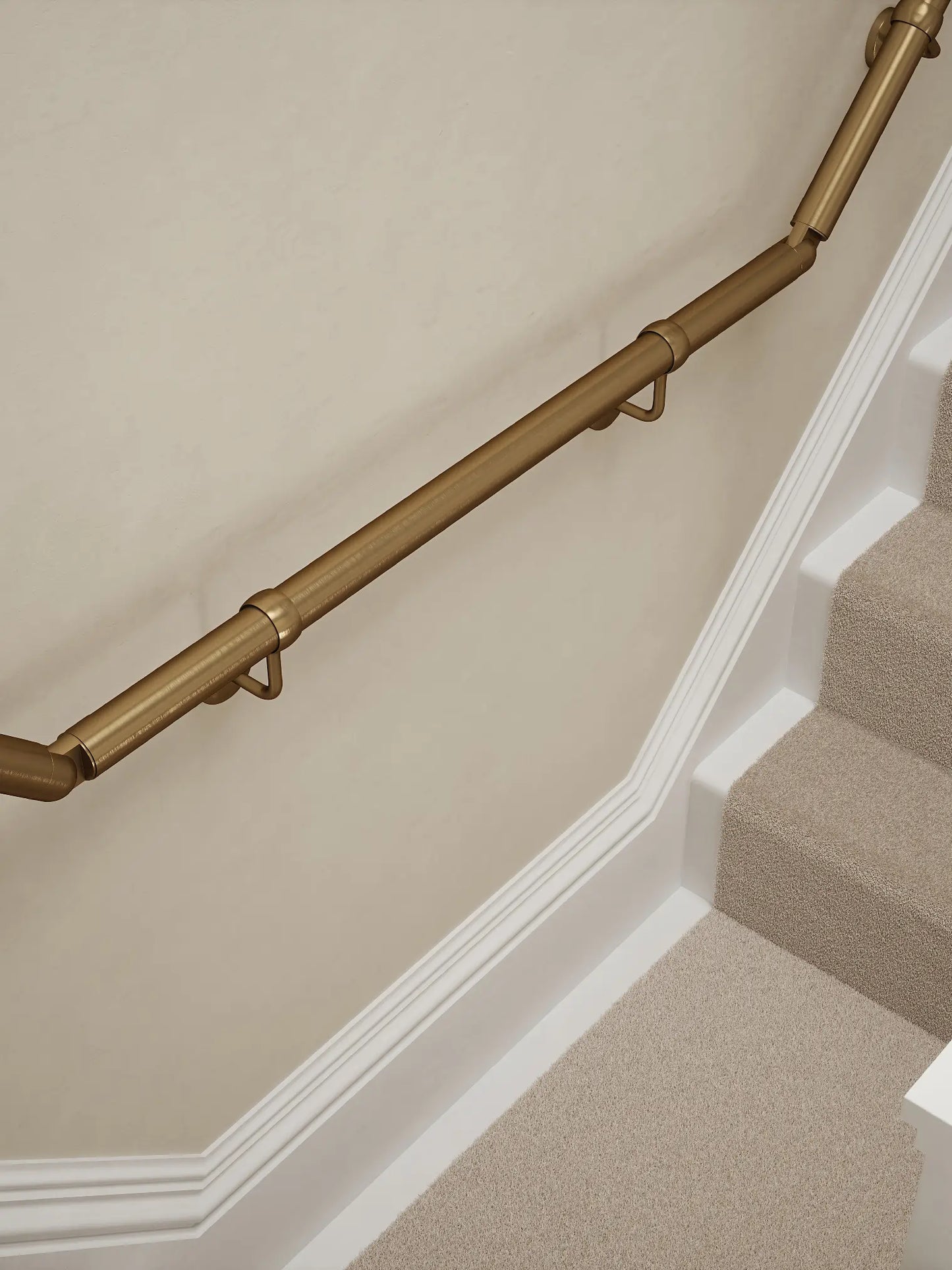 Loxley Antique Brass wall-mounted handrail installed on a T-shape staircase, alternate front view – Handrails Direct UK supplier of modular indoor handrails and fittings